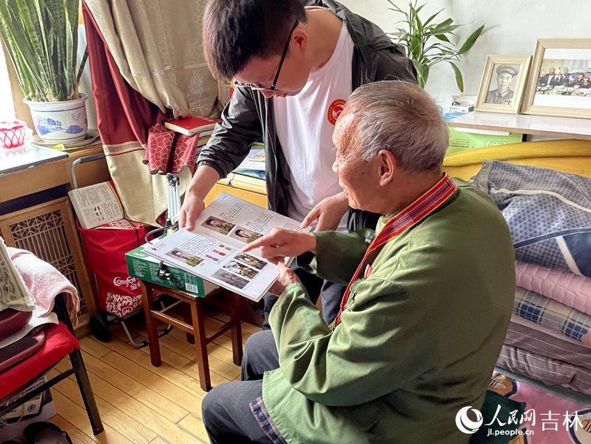 向德明向大家展示參軍時的老照片。人民網記者 李思玥攝