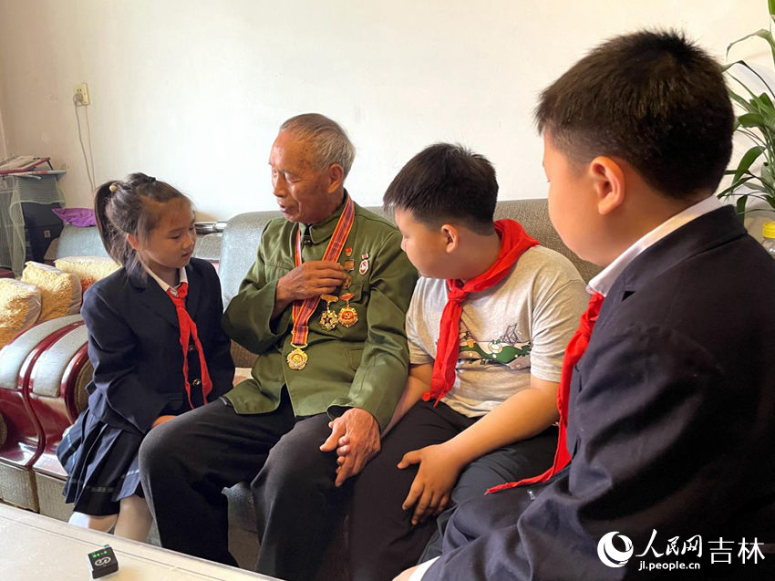 向德明同少先隊員們講述勛章背后的故事。人民網記者 李思玥攝