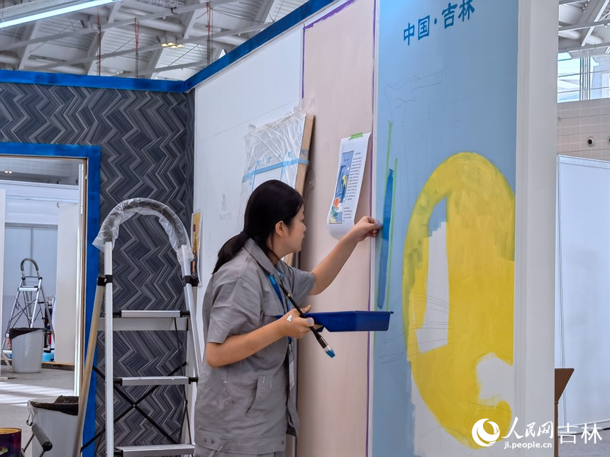 油漆與裝飾賽項選手龍彥池繪制墻面。人民網記者 馬俊華攝