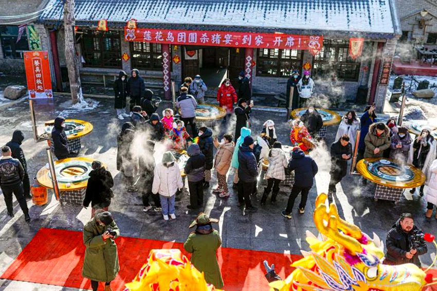 鄉村年豬文化節上，游客圍著鐵鍋燉大快朵頤。長春市朝陽區供圖
