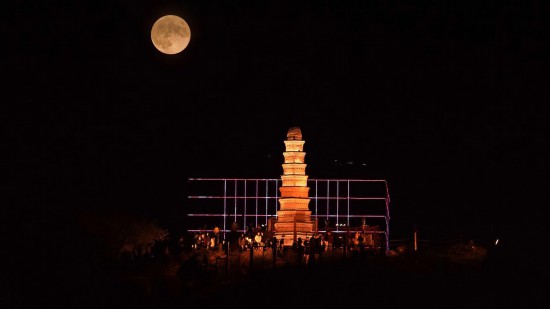 9月29日晚，中秋圓月升起，與新疆烏魯木齊地標建筑紅山塔重疊（二次曝光）。人民網 李欣洋攝